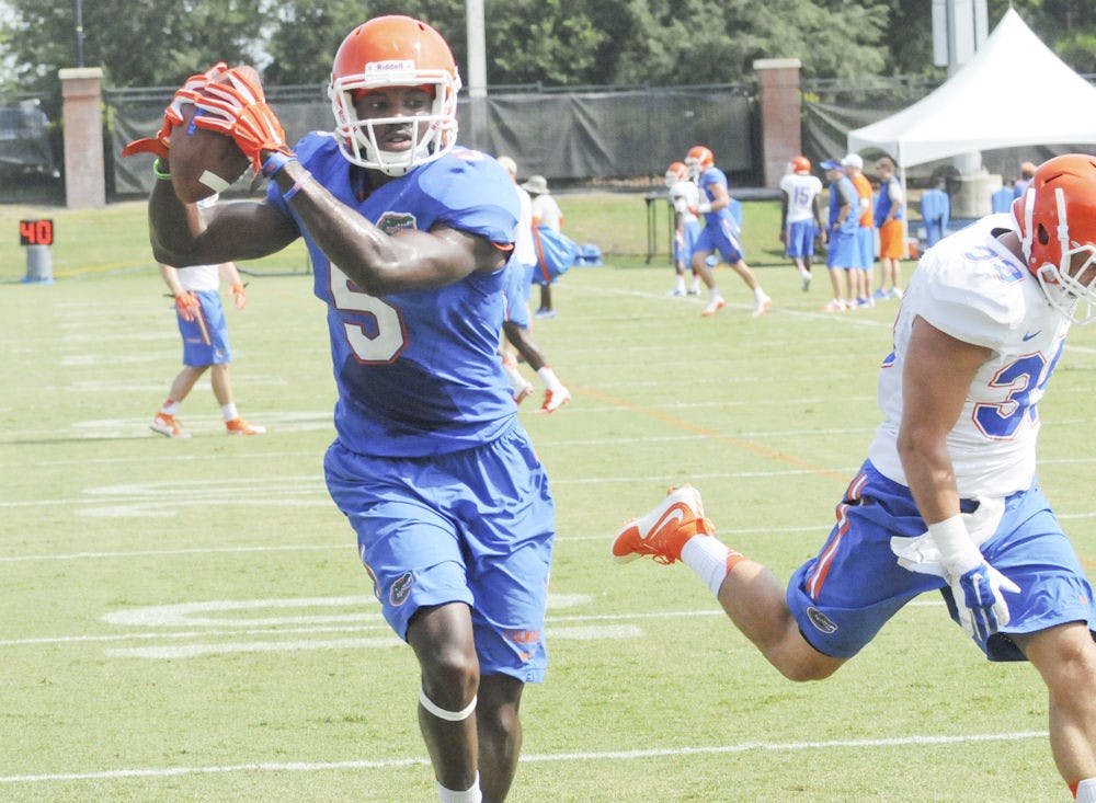 <p>UF wide receiver Ahmad Fulwood catches a pass from quarterback Will Grier (not pictured) during practice Aug. 8, 2015, at Donald R. Dizney Stadium.</p>