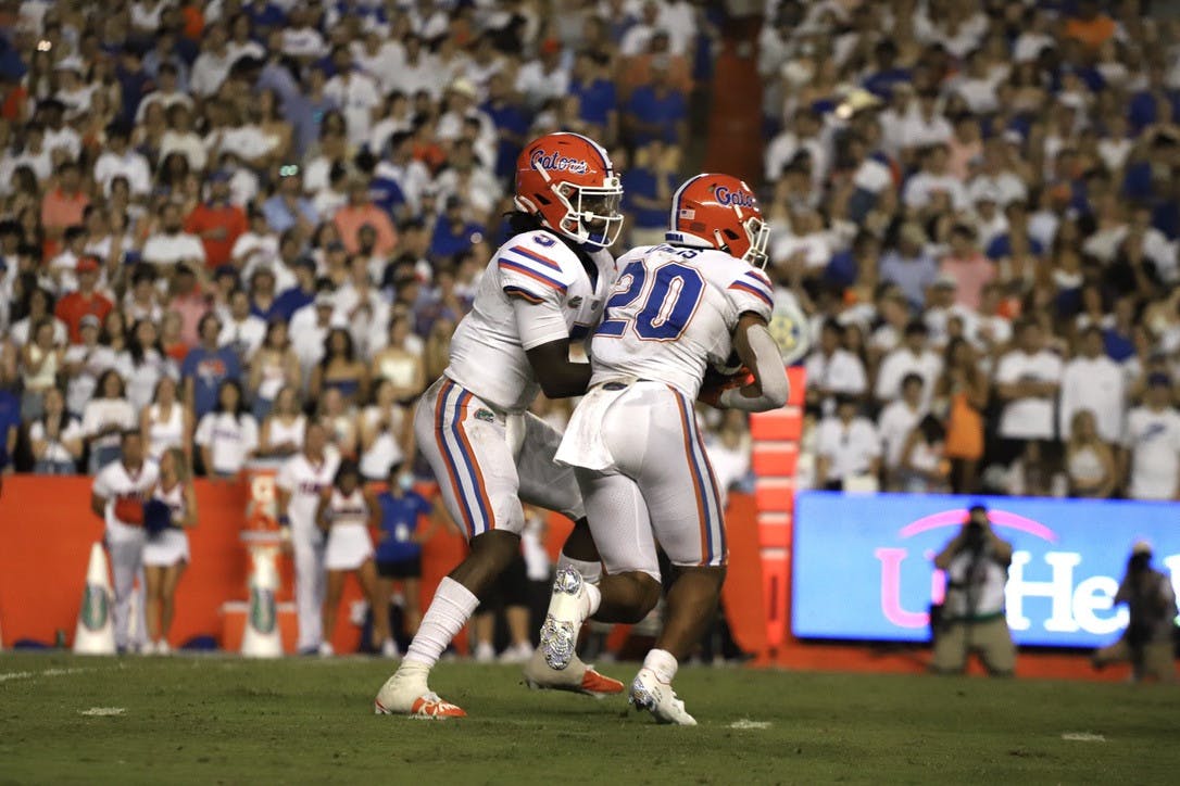 Malik Davis (20) takes a handoff from Emory Jones during Florida's season-opening 35-14 victory over Florida Atlantic on Sept. 4.