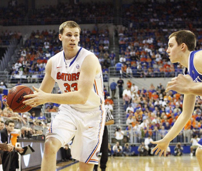 Senior forward Erik Murphy (33) attempts a pass during Florida’s 69-52 win against Kentucky on Feb. 12 in the O’Connell Center. The Chicago Bulls selected Murphy 49th overall on Thursday night in the 2013 NBA Draft.&nbsp;