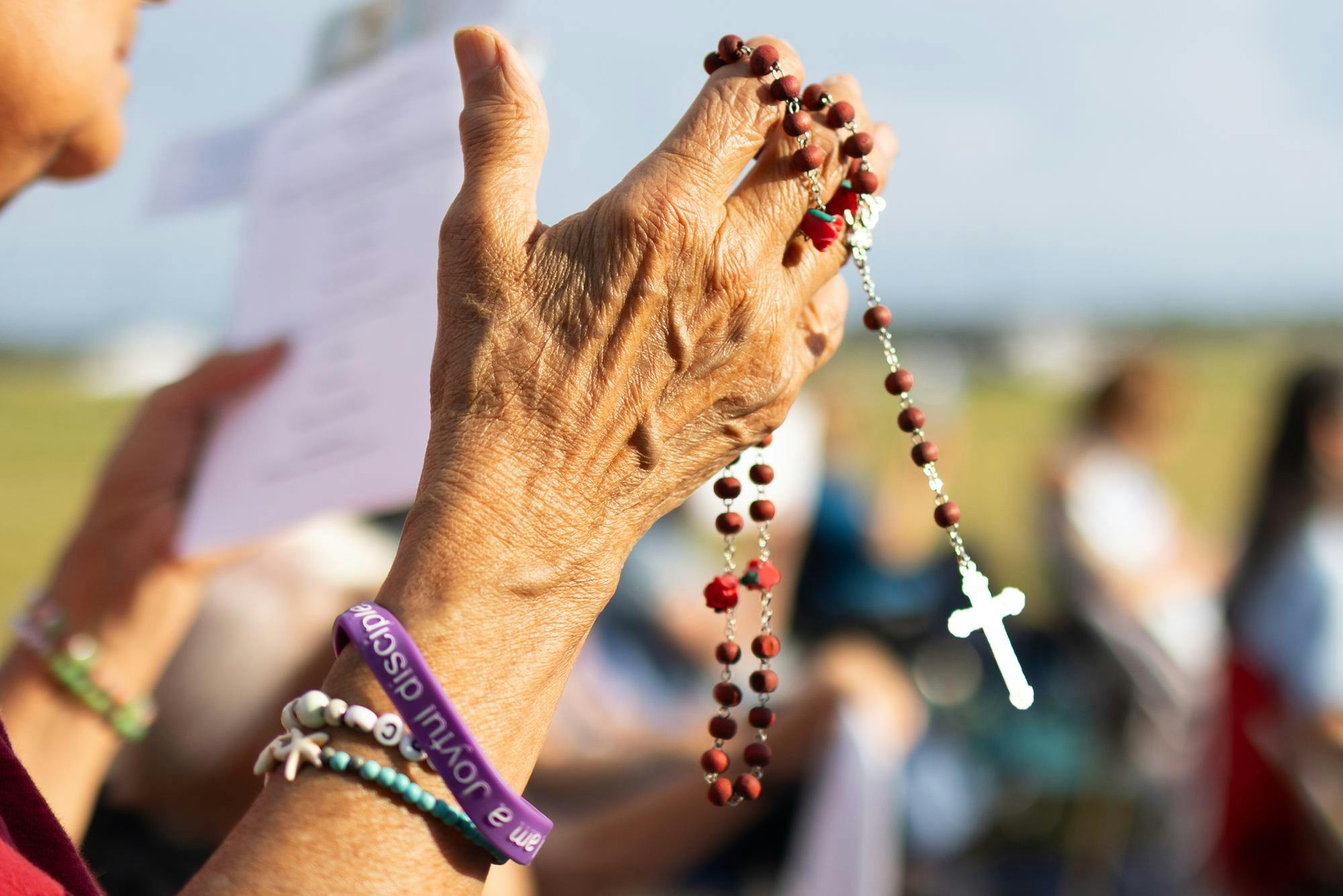 A demonstrator holds a rosary during a protest against the death penalty at the Florida State Prison, Tuesday, Sept. 29, 2026 in Raiford, Fla.