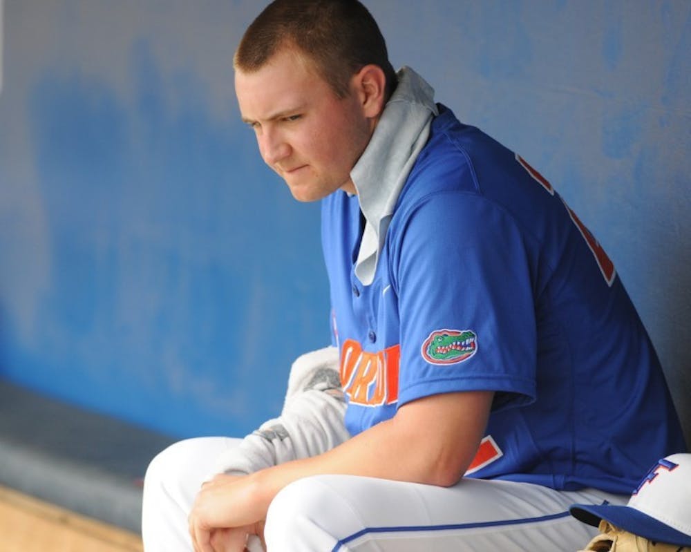 <p>Starter Karsten Whitson sits in the Gators’ dugout following a game against USF last season. Whitson has not pitched since an abbreviated outing on Feb. 26.</p>