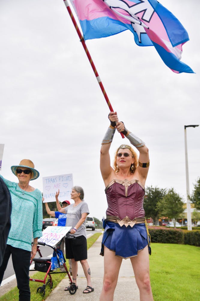 Melina Rayna Svanhild Farley-Barratt, a 39-year-old Gainesville activist, waves a transgender flag during the “Won’t Be Erased!” rally Tuesday afternoon. The Trans Rights Action Committee hosted the event outside Hobby Lobby as a response to President Trump’s statement recently about eliminating the status of transgender and having a person’s sex be determined at birth. The Hobby Lobby was chosen as the location due to its public stance against the LGBTQ+ community.