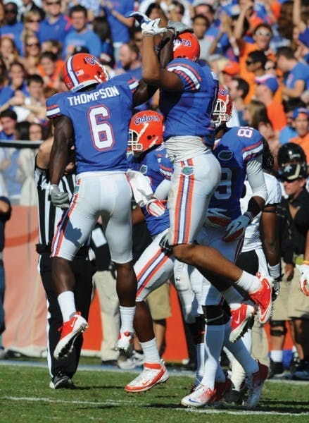 Deonte Thompson (6) and Jordan Reed (center), members of UF’s hands team, celebrate after corraling Vanderbilt’s onside kick late in Saturday’s 26-21 win.