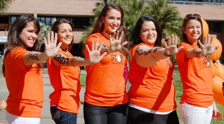 Members of UF’s Bateman Team strike their signature pose during the “Spot It, Stop It” anti-bullying campaign Tuesday afternoon on the Reitz Union North Lawn.