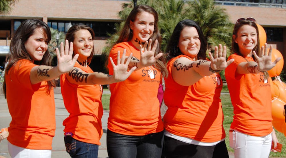 <p>Members of UF’s Bateman Team strike their signature pose during the “Spot It, Stop It” anti-bullying campaign Tuesday afternoon on the Reitz Union North Lawn.</p>