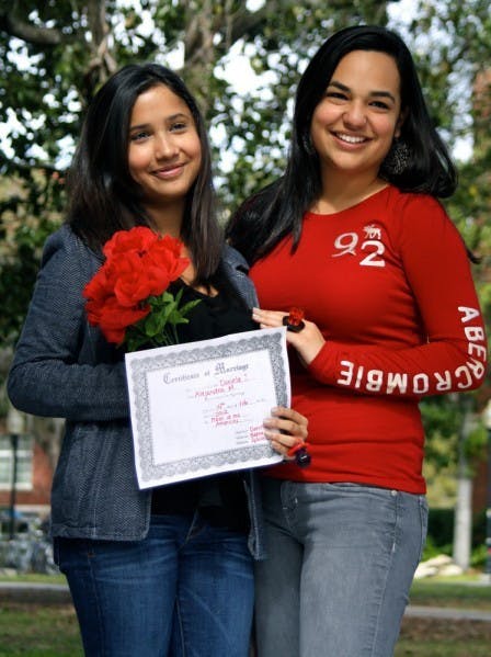 Biology freshman Daniela Sanchez and finance freshman Alejandra Miyares get married on the Plaza of the Americas on Tuesday afternoon. Delta Sigma Pi hosted the wedding ceremonies, complete with bridal bouquet, optional bow tie and Ring Pop exchange for a $3 donation to the American Cancer Society.