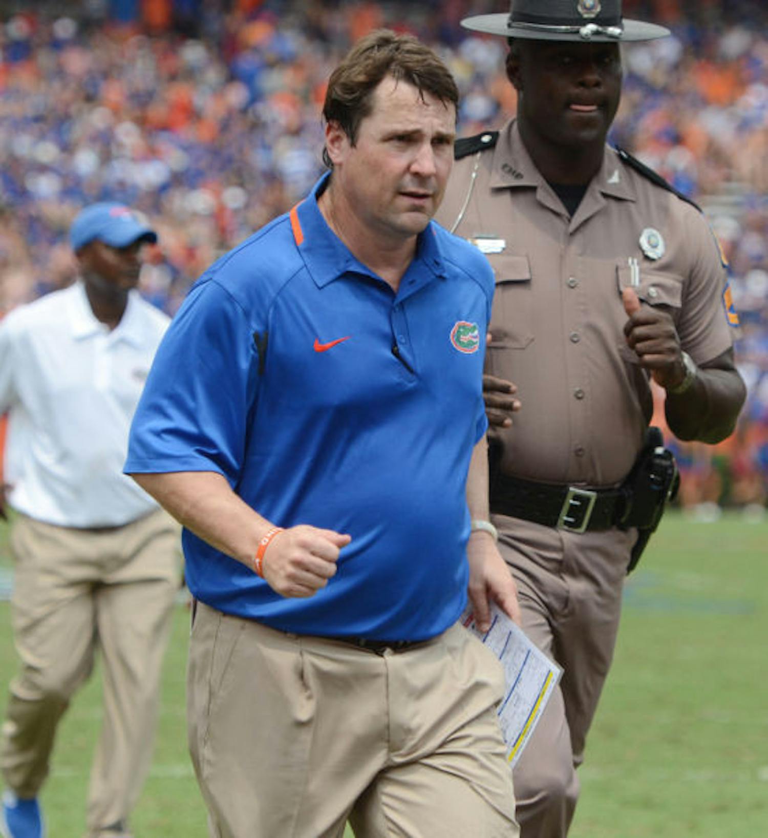 Will Muschamp walks toward the locker room following the first half of Florida’s 24-6 victory against Toledo on Saturday in Ben Hill Griffin stadium.