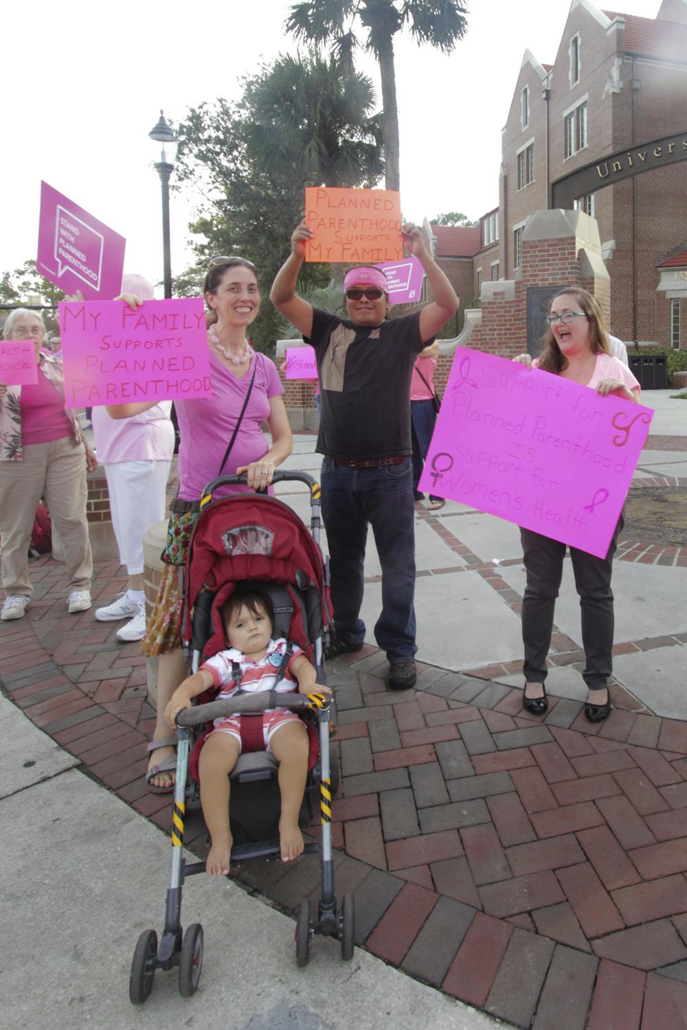 <p>Tamara Leisey (left), her husband Silvestre Hernandez, their 1-year-old son Ollin Hernandez-Leisey and Rawlings Elementary ESE teacher Christe McGann rally Sept. 29, 2015. Leisey said she and Hernandez went to the organization for medical tests before getting pregnant with Ollin. “I think a lot of people forget about the actual family-planning portion of their services,” she said. “It’s not just women’s healthcare. It’s men’s healthcare as well.”</p>