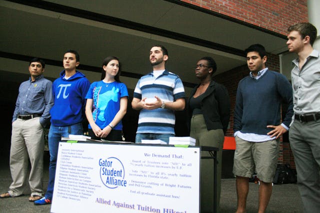 Members of the Gator Student Alliance speak during a press conference on Turlington Plaza on Monday afternoon to protest tuition hikes and Bright Futures Scholarship program cuts.