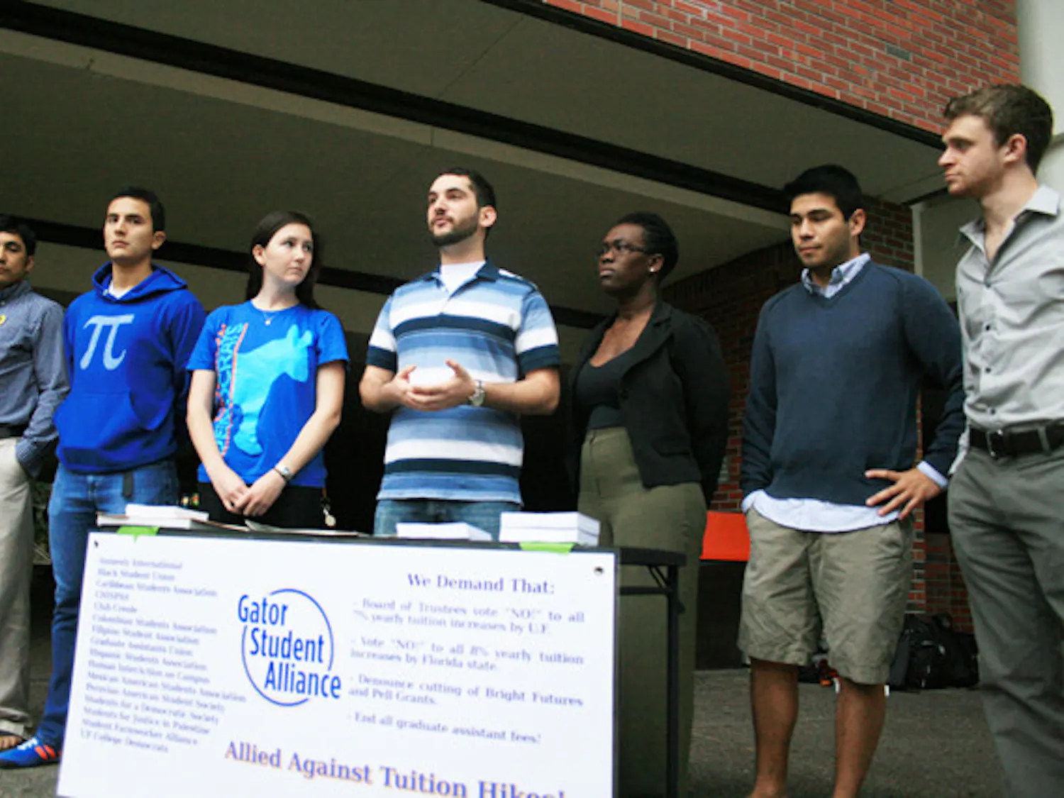 Members of the Gator Student Alliance speak during a press conference on Turlington Plaza on Monday afternoon to protest tuition hikes and Bright Futures Scholarship program cuts.