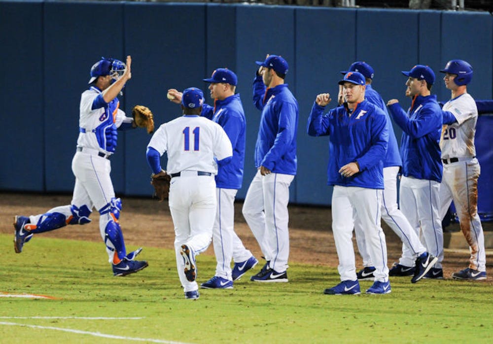 <p>Florida celebrates after an inning during it’s 4-0 win against Maryland on Feb. 14 at McKethan Stadium.</p>