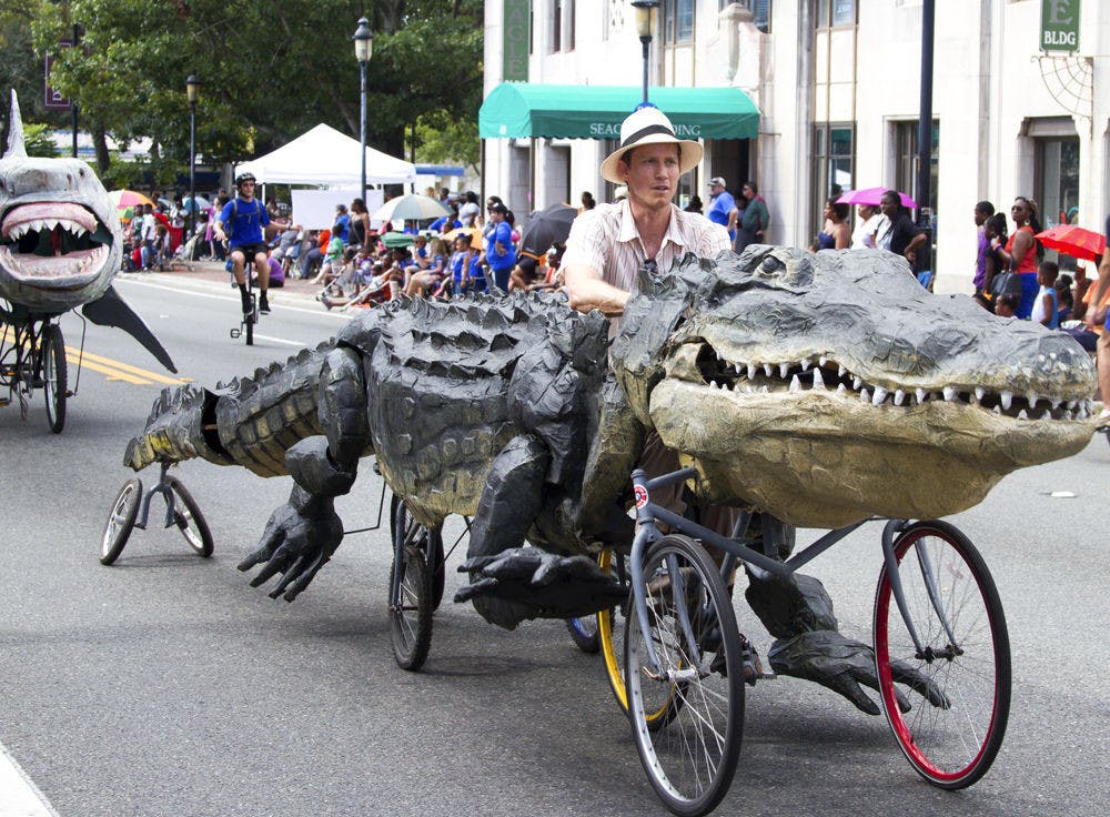 Raymond Rawls rides one of his custom-made floats down University Avenue during the UF Homecoming Parade on Nov. 6, 2015. Of his five creations that will be featured at the Menagerie in Motion event on Saturday, Rawls said the alligator his favorite.