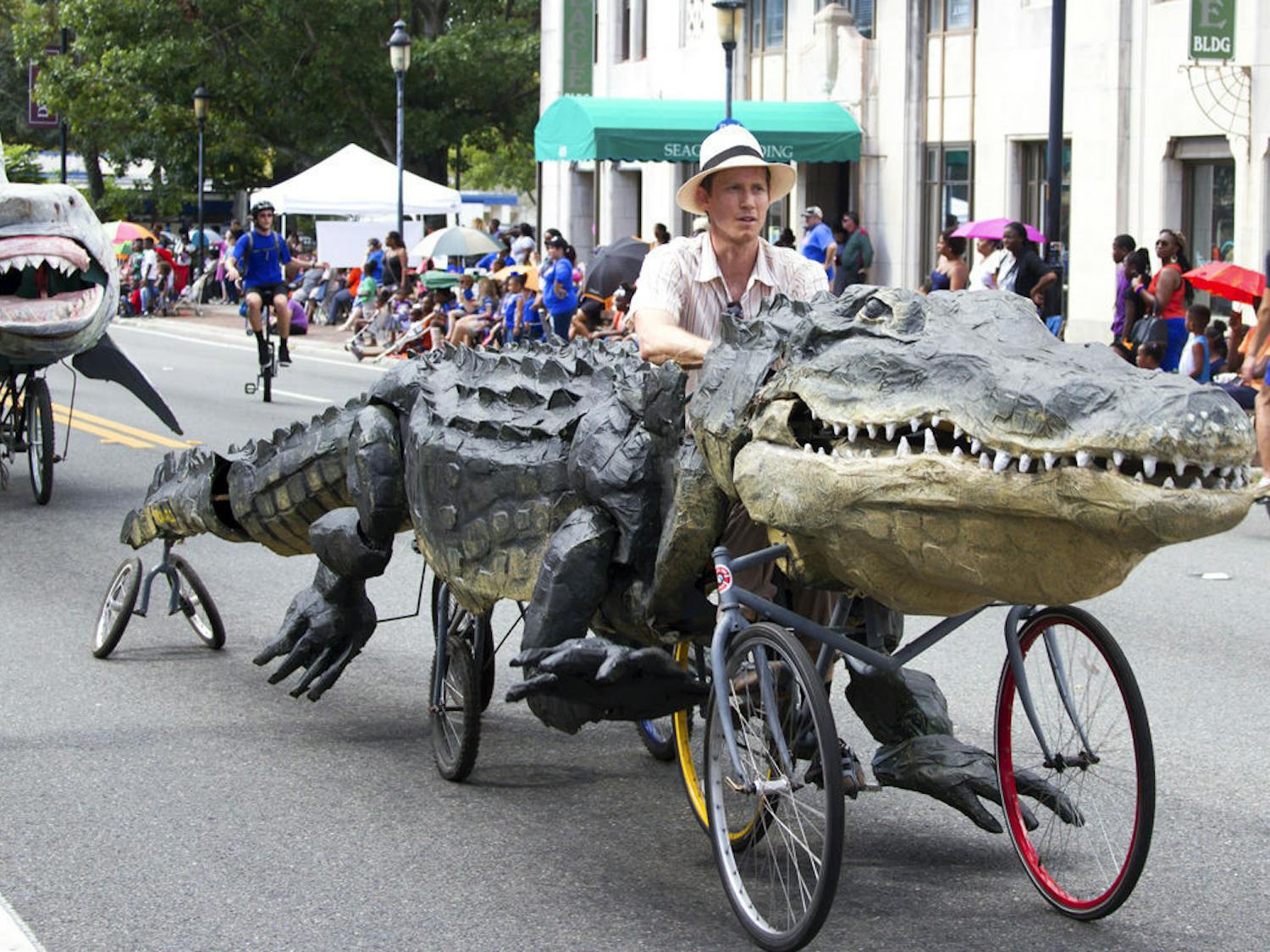 Raymond Rawls rides one of his custom-made floats down University Avenue during the UF Homecoming Parade on Nov. 6, 2015. Of his five creations that will be featured at the Menagerie in Motion event on Saturday, Rawls said the alligator his favorite.