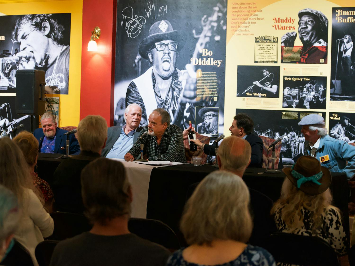 Jeffrey Meldon (left), Jim Forsman, Bill DeYoung, Albert Teebagy, and John Moran discuss Moran’s pictures displayed at the Matheson History Museum Friday, Feb. 24, 2023.