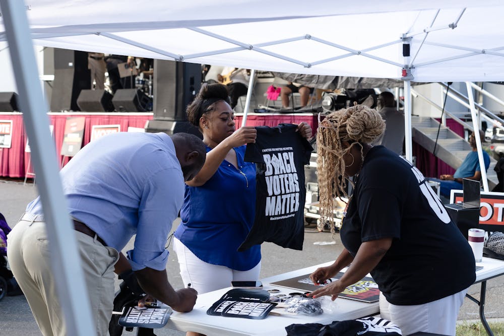 <p>Woman hands out T-shirts at the Souls to the Polls event on Nov. 3, 2024.</p>