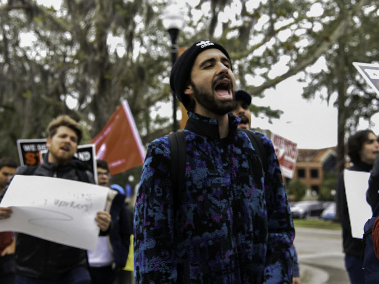 Anton Kernohan, a 20-year-old UF political science and sustainability sophomore, chants as protesters walk from Plaza of the Americas to the front entrance of Tigert Hall on Friday. 
