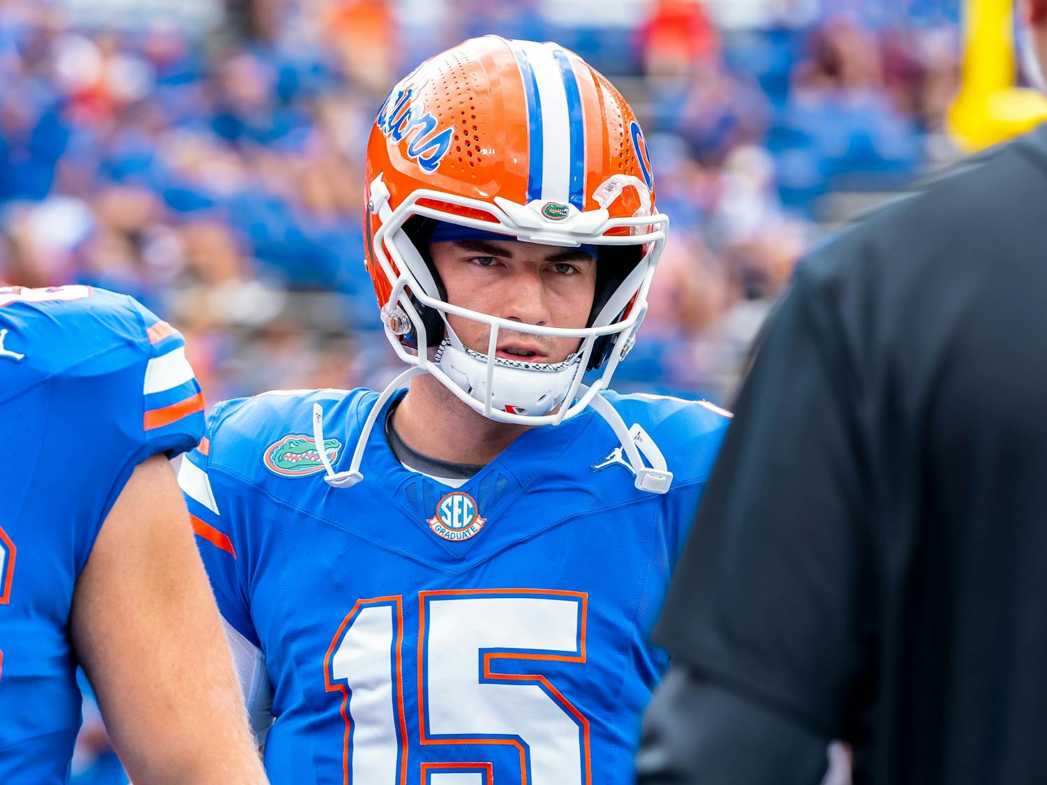 Gator quarterback Graham Mertz talks to a Florida coach before the game against Texas A&M on Saturday, Sept. 14, 2024.