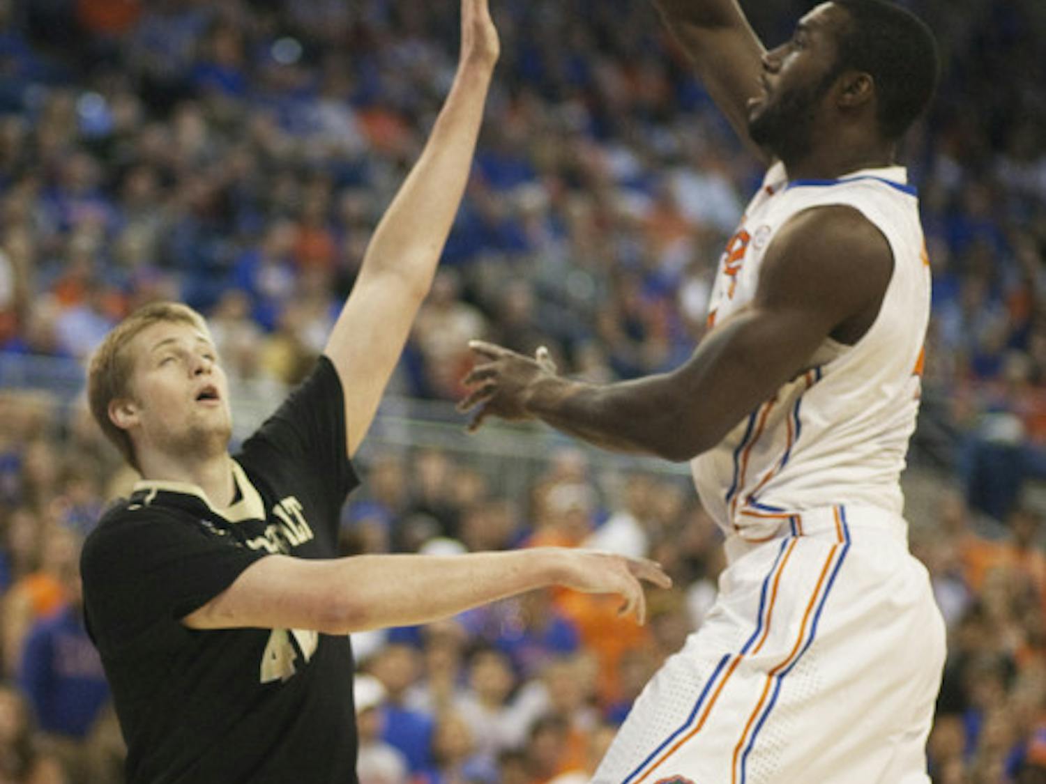 Junior center Patric Young (right) attempts a hook shot during Florida’s 66-40 win against Vanderbilt on March 6 in the O’Connell Center. .