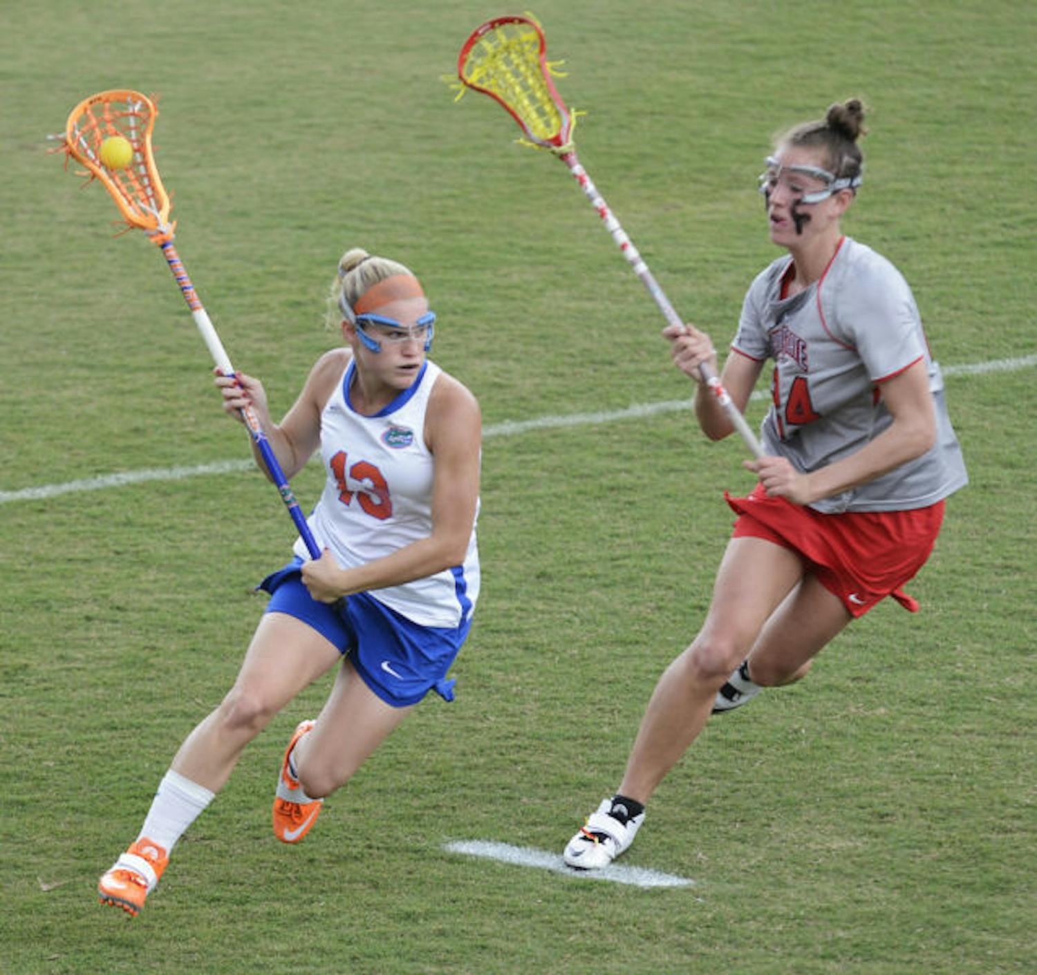 Florida attacker Ashley Bruns (13) runs past Ohio State defender Tayler Kuzma (24) in the Gators’ 13-7 win against the Buckeyes on March 23 at Dizney Stadium. Bruns scored four goals in Florida's 16-5 win against Denver in the second round of the NCAA Tournament.