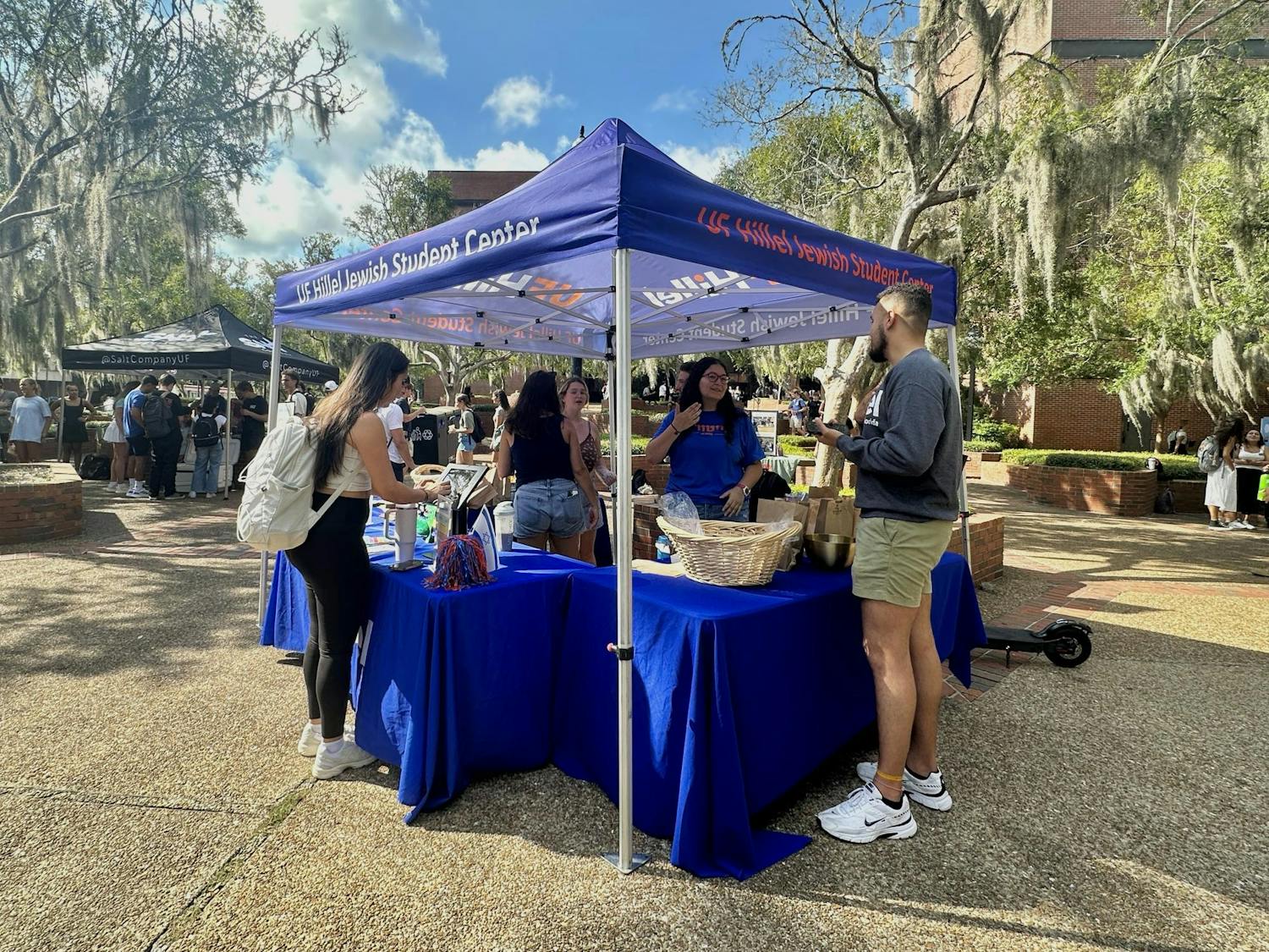 Members of the UF Hillel Jewish Student Center talk to students by Turlington Hall on the first day of classes.