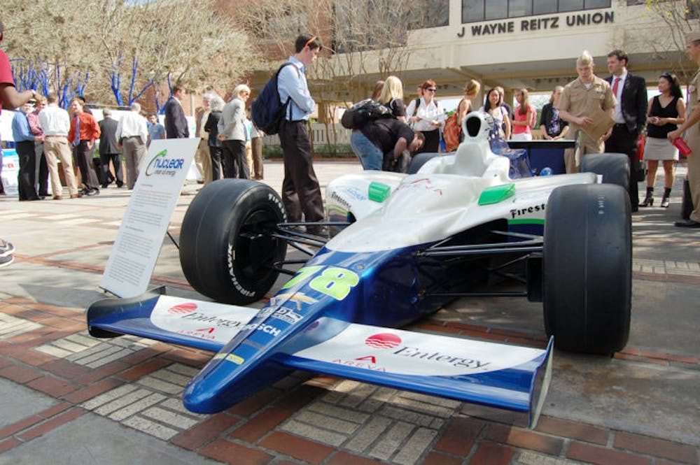 <p>Passers-by gaze at the Nuclear Clean Air Energy car driven by IZOD IndyCar racer Simona De Silvestro, 24, displayed Tuesday afternoon on the Reitz Union North Lawn as part of KV Racing Technology and Entergy Nuclear teaming up to promote the "Nuclear Clean Air Energy" public awareness program.</p>