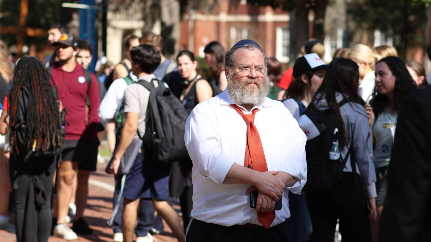 Rabbi Berl Goldman walks through the crowd of students gathered in Plaza of the Americas as an antisemitic group &quot;Ye is Right&quot; attempts to interview people on campus Thursday, Feb. 2, 2023. 