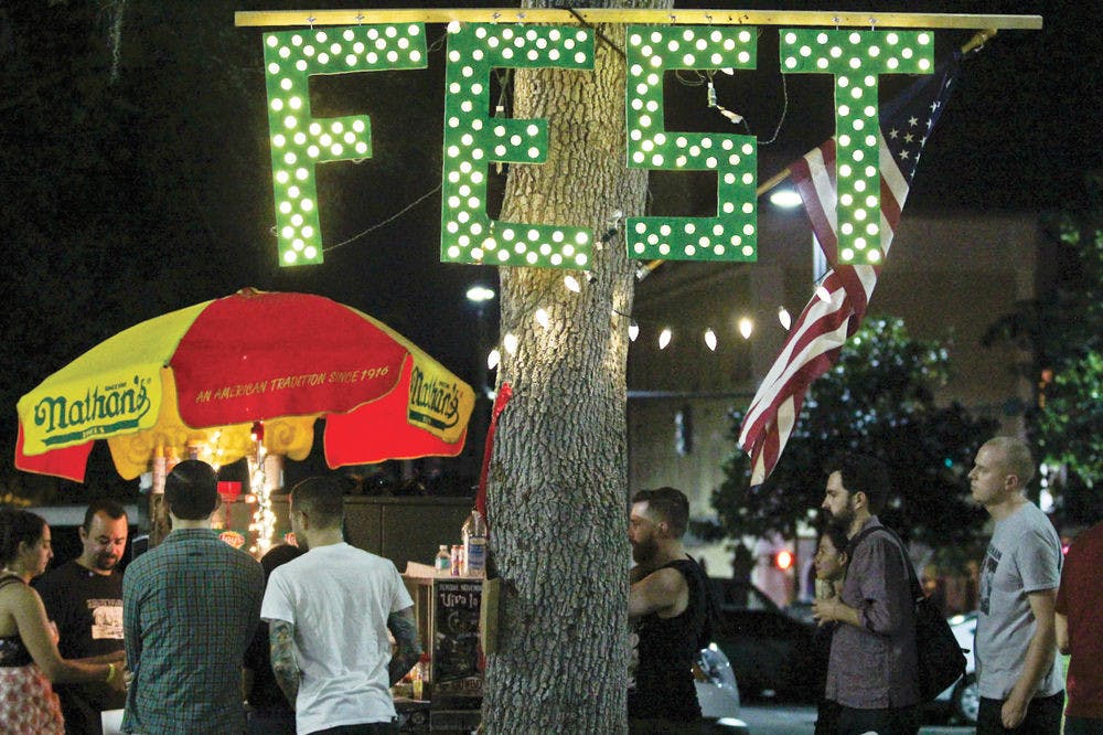 <p>Festival-goers crowd a hot dog stand during FEST 14 on Oct. 31, 2015.</p>