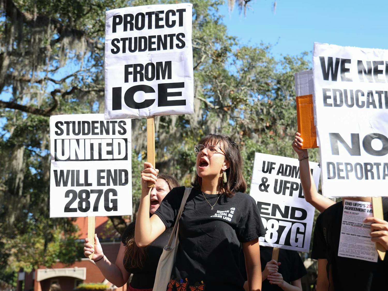 Katherine Canev holds a sign at a Students for Socialism at the University of Florida walkout to demand UFPD end its 287(g) agreement with ICE at Turlington Plaza, Thursday, Nov. 20, 2025.