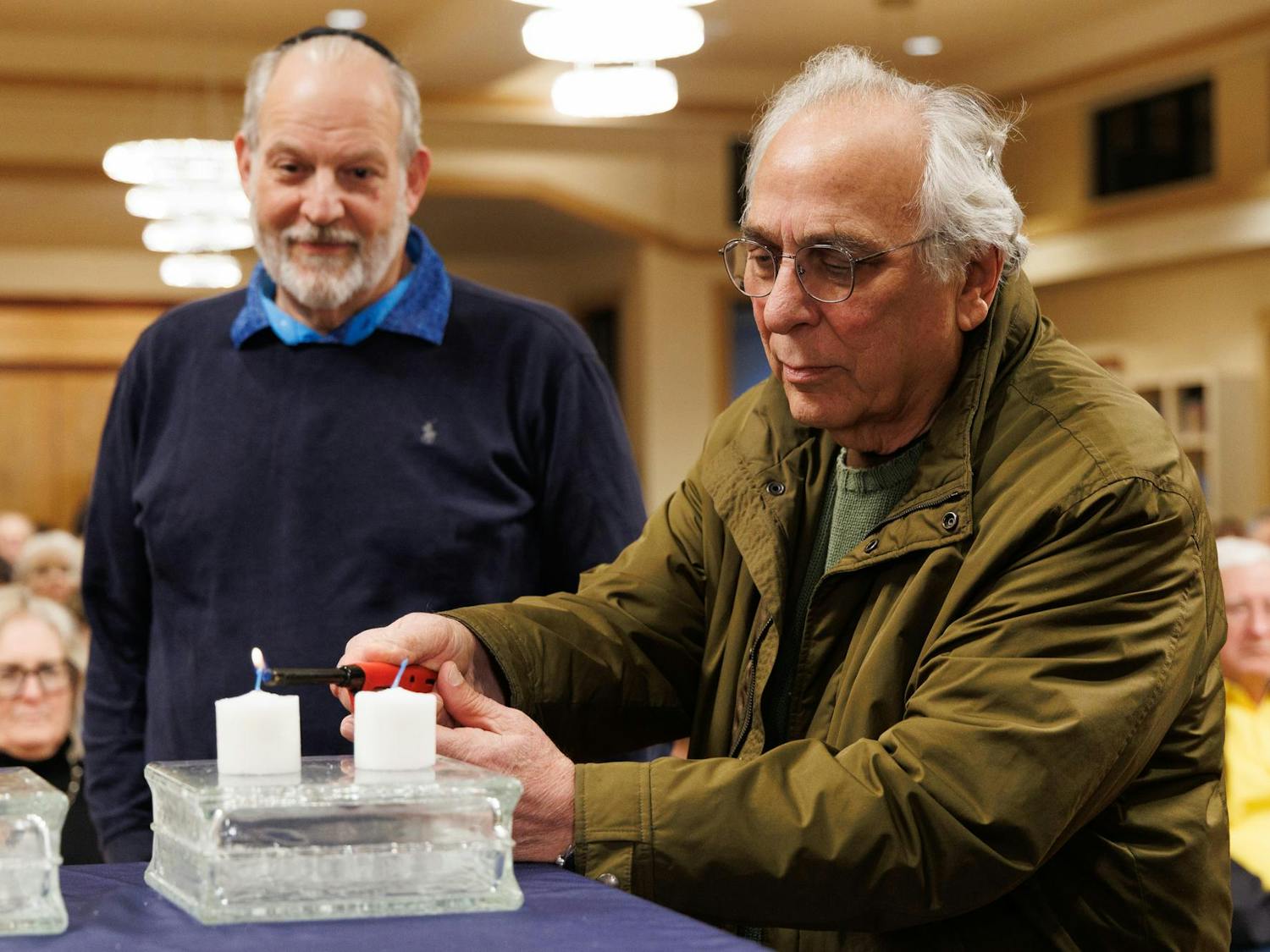 Dr. Marvin Slott lights a candle at an International Holocaust Remembrance Day event at the Chabad UF Jewish Center in Gainesville, Fla., Wednesday, Jan. 21, 2026.