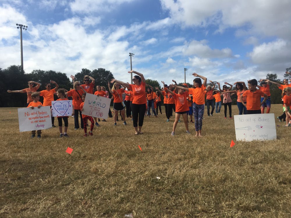 <p><span id="docs-internal-guid-101fe45d-b41f-1a26-dc75-1bc02ac7f60d"><span>Children and adults gather on Flavet Field to participate in Gainesville’s first “Dance for Kindness.” They were among thousands around the world who danced in honor of World Kindness Day, which is today.</span></span></p>