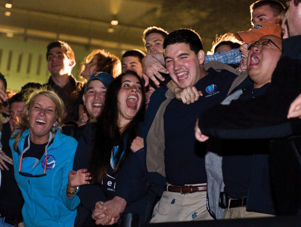 Newly elected Student Body President Ben Meyers, second from right, celebrates the announcement of his winning at the Reitz Union Amphitheater early Thursday morning. Meyers’ Unite Party took 39 student senate seats, while the  Progress Party took 11 seats.