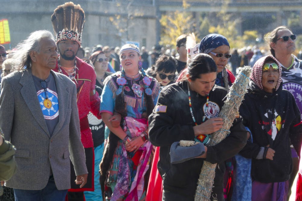 A group of indigenous peoples lead a march of protestors against fracking and shale gas through Point State Park before a ceremony to bless the three rivers, Wednesday, Oct. 23, 2019, in Pittsburgh. The group is protesting before President Donald Trump is to speak at at the Shale Insight Conference Wednesday afternoon. (AP Photo/Keith Srakocic)
