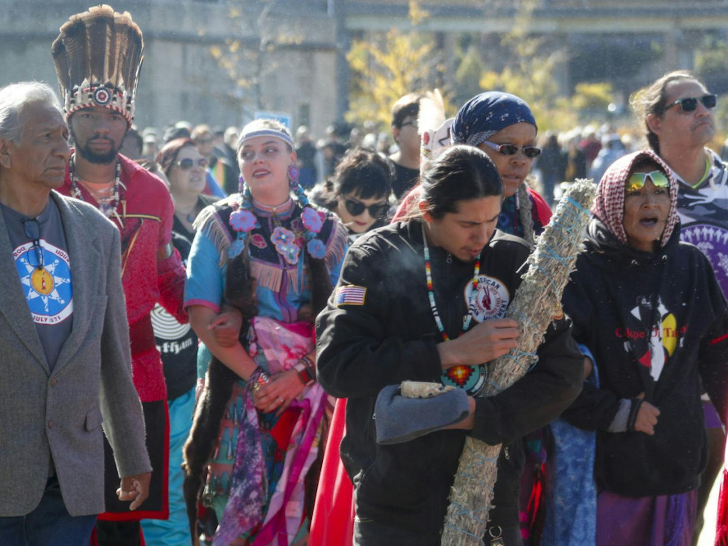 A group of indigenous peoples lead a march of protestors against fracking and shale gas through Point State Park before a ceremony to bless the three rivers, Wednesday, Oct. 23, 2019, in Pittsburgh. The group is protesting before President Donald Trump is to speak at at the Shale Insight Conference Wednesday afternoon. (AP Photo/Keith Srakocic)