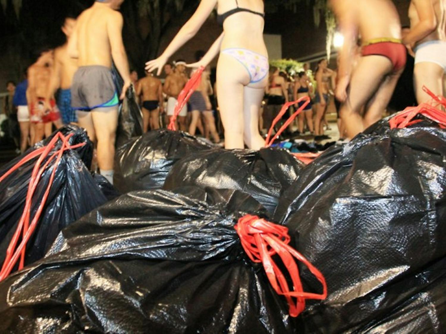 Participants in the Fall 2012 Underwear Dash strip off their clothes, which will be donated to St. Francis House, a Gainesville homeless shelter and soup kitchen. About 24 trash bags of clothing were donated.