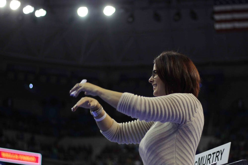 <p>UF coach Jenny Rowland applauds after Alex McMurtry’s balance beam routine during Florida’s win against Alabama on Jan. 29, 2016, in the O’Connell Center.</p>