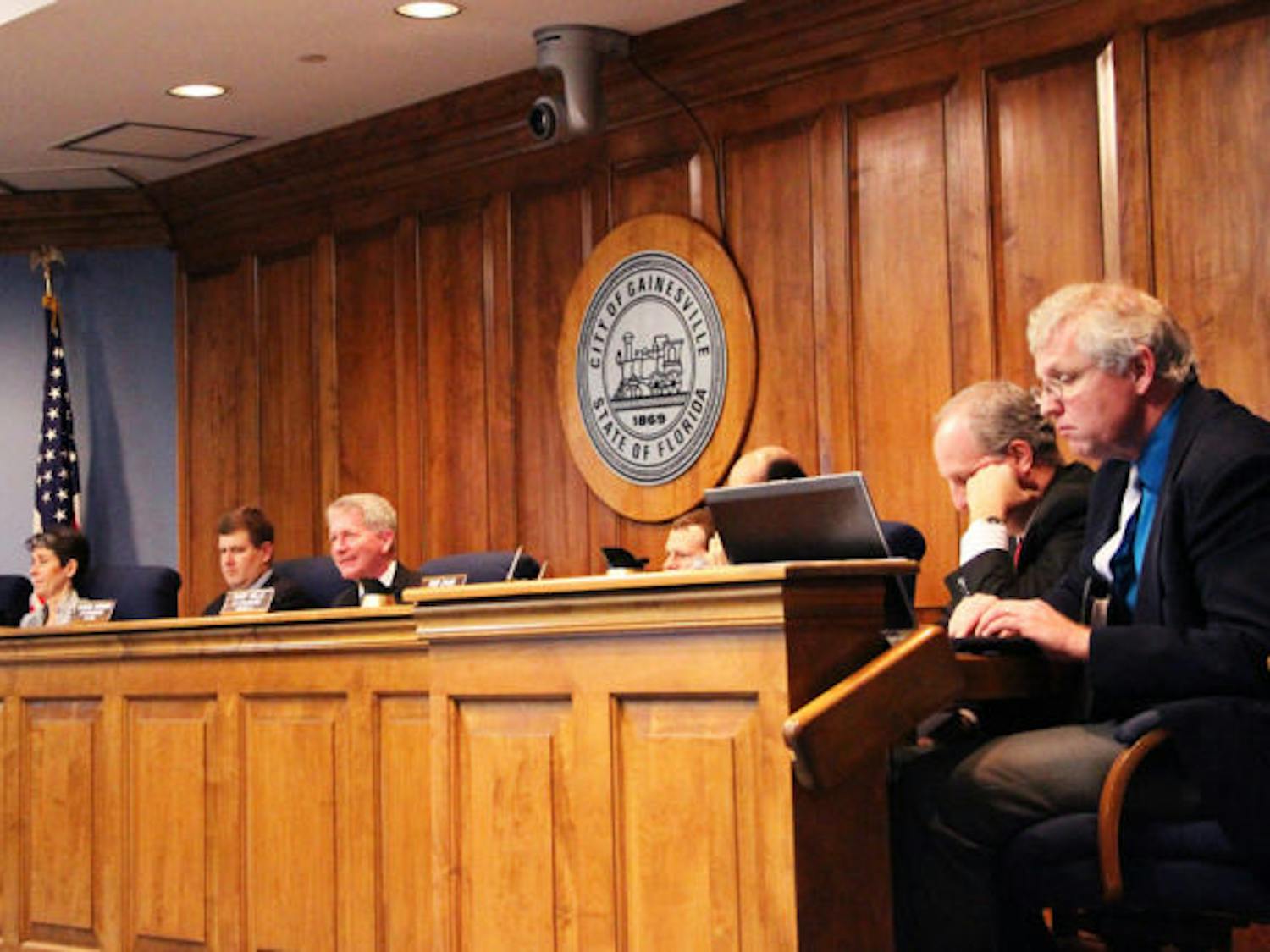 Gainesville City Commissioners discuss the current neighborhood parking decal system Thursday. They unanimously passed a resolution to explore options of raising parking permit prices.