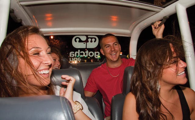 Left to right: Marisa Dunkel, Meagan Kaufman, John Slate and Alison Carestia cruise in a GOTCHA Ride down University Avenue on the way to midtown Wednesday night.