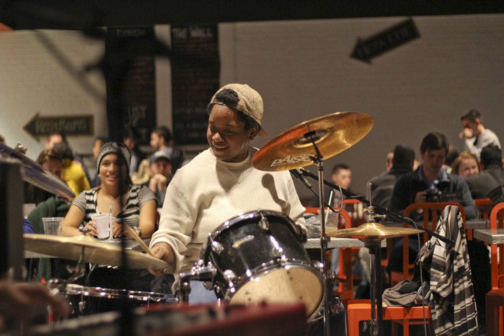 <p>Destinee Collins, a 25-year-old drummer for the cover band timesUp and a worker at Dough Religion Pizza, jams out to cover songs like “Brick House” on Jan. 6, 2016 at the Oozoo Bar.</p>