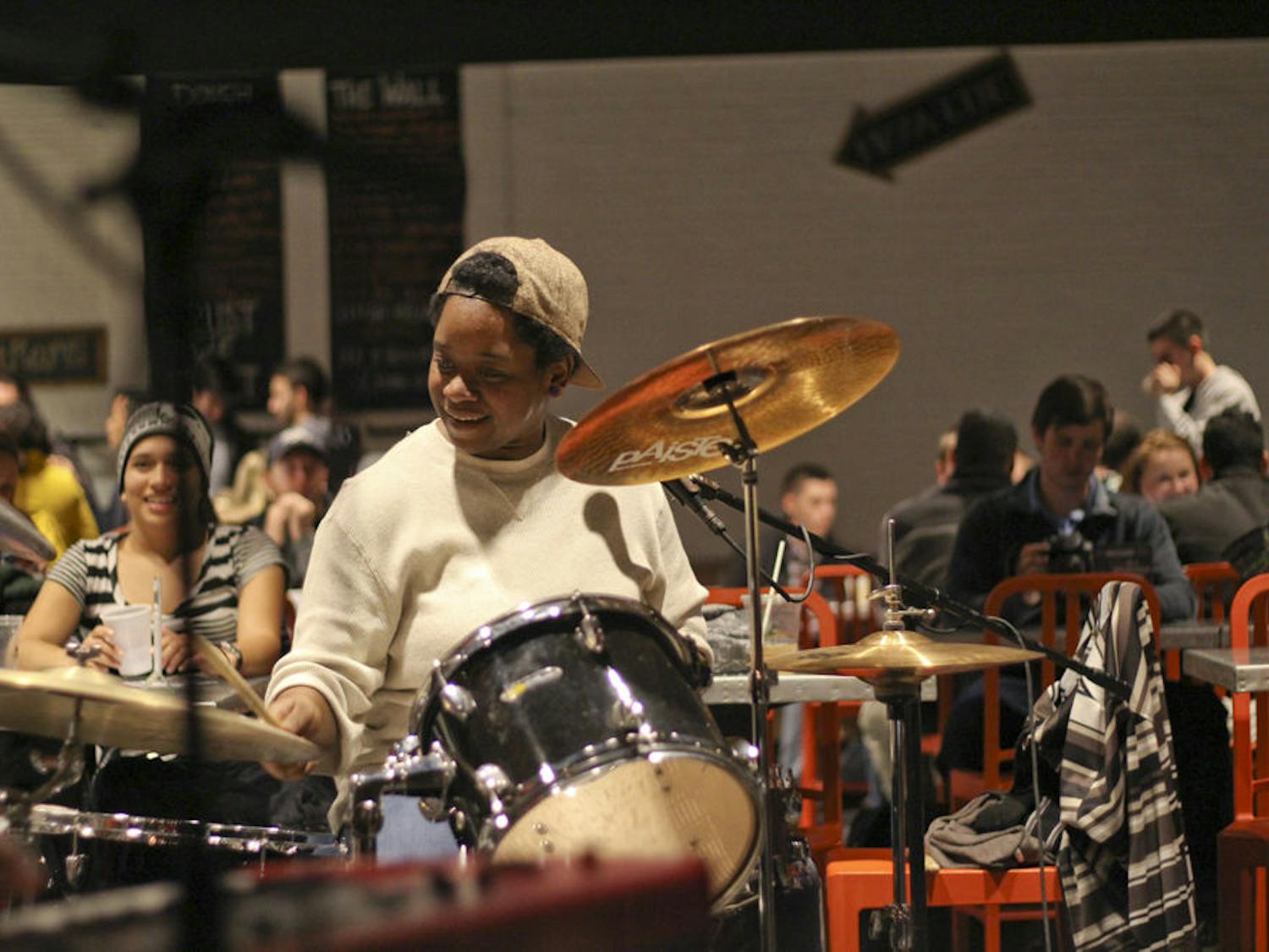 Destinee Collins, a 25-year-old drummer for the cover band timesUp and a worker at Dough Religion Pizza, jams out to cover songs like “Brick House” on Jan. 6, 2016 at the Oozoo Bar.