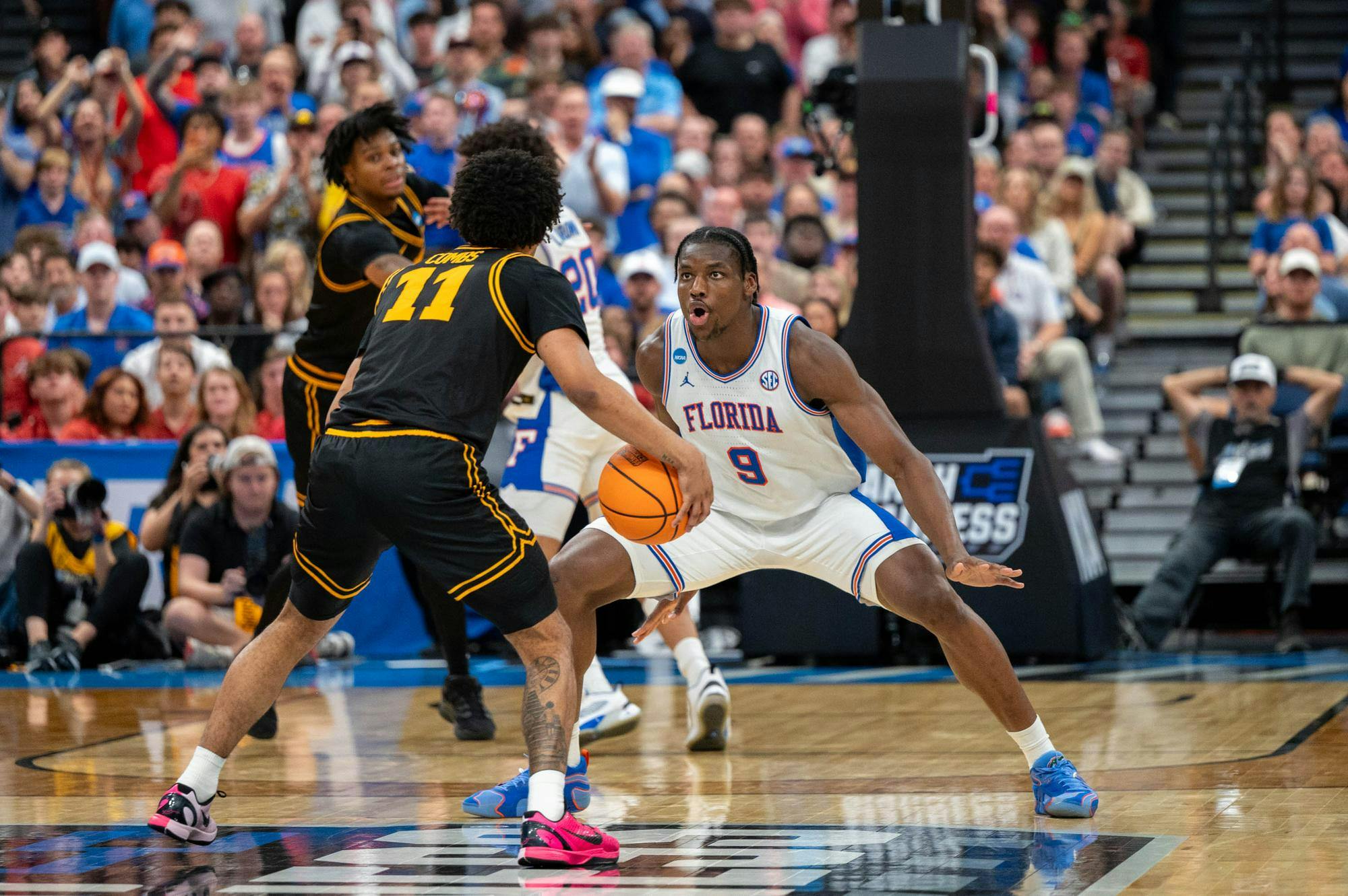 Florida center Rueben Chinyelu (9) guards Iowa guard Kael Combs (11) during the second half of an NCAA Tournament second round game, Sunday, March 22, 2026, in Tampa, Fla.