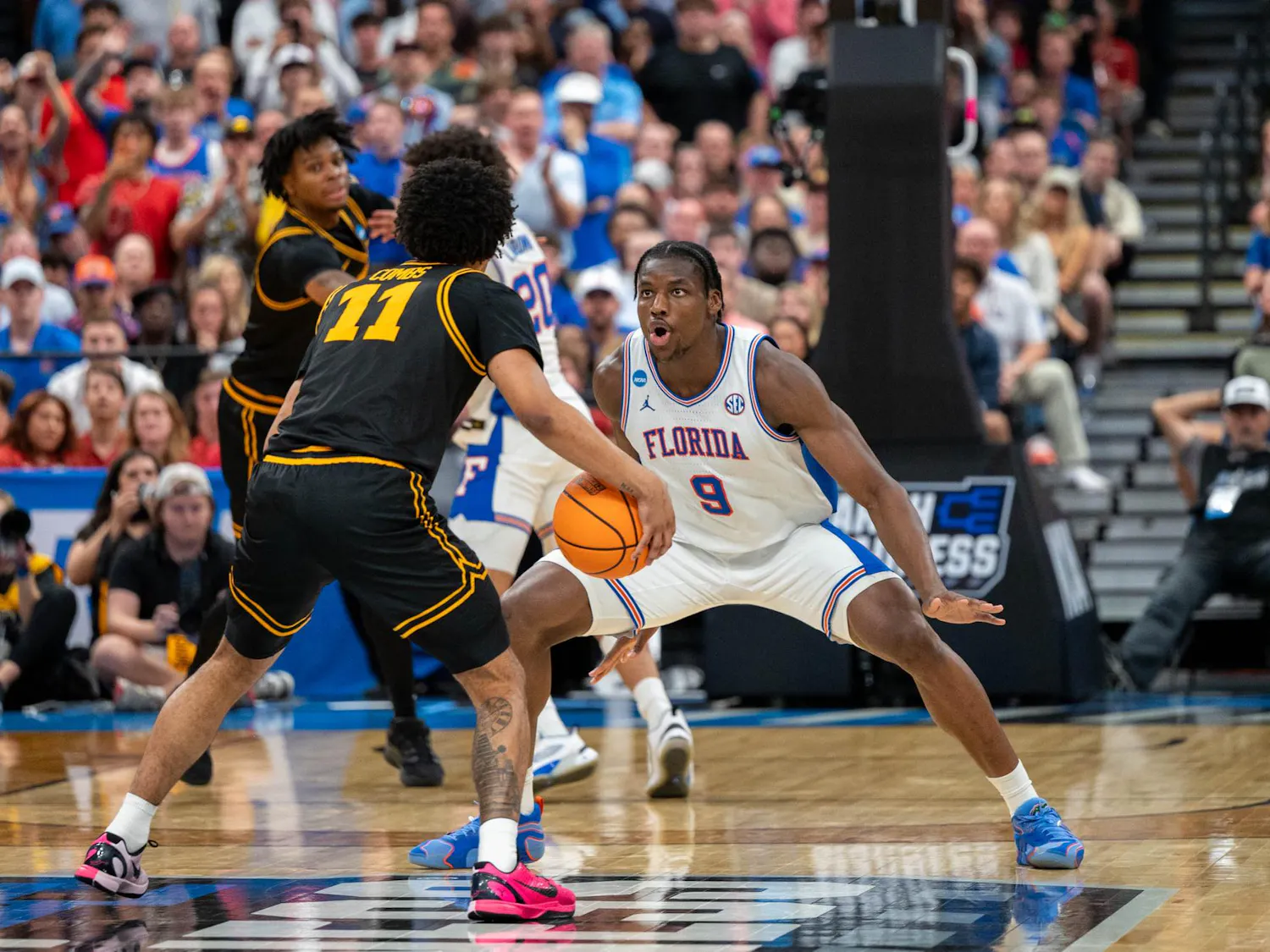 Florida center Rueben Chinyelu (9) guards Iowa guard Kael Combs (11) during the second half of an NCAA Tournament second round game, Sunday, March 22, 2026, in Tampa, Fla.