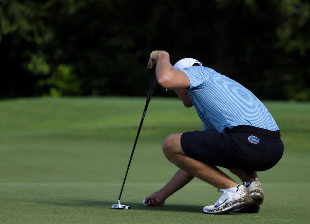 Florida's Joe Pagdin reads a putt at Mark Bostick Golf Course in Gainesville, Florida. Pagdin was one of four underclassmen to play in every spring tournament for the Gators and the SEC Freshman of the Year highlights the team's youth.