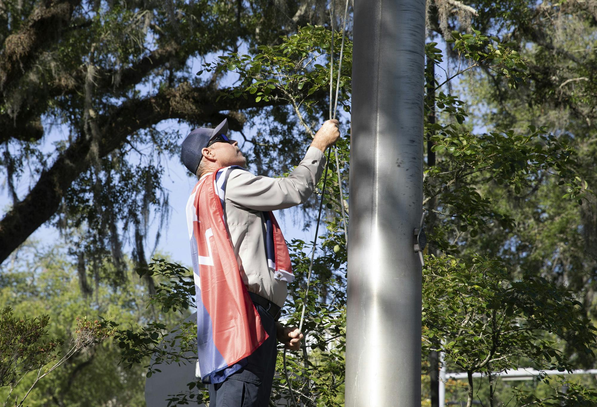George Cannon, a supervisor of the Gainesville downtown area, raises the Juneteenth flag on Thursday, May 20, 2021.