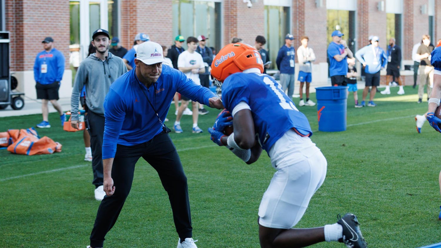 Florida football head coach Jon Sumrall helps with a drill during spring training camp at the Heavener Football Training Center in Gainesville, Fla., Tuesday, March 10, 2026.