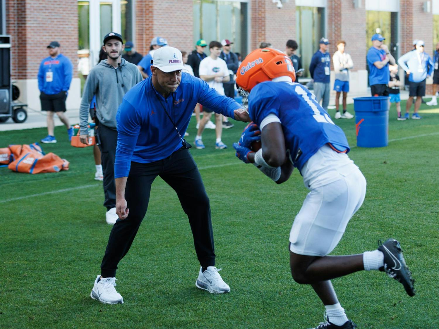 Florida football head coach Jon Sumrall helps with a drill during spring training camp at the Heavener Football Training Center in Gainesville, Fla., Tuesday, March 10, 2026.