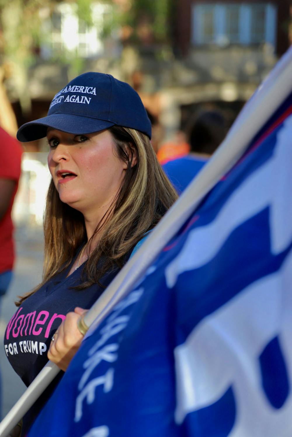 <p dir="ltr">Raemi Eagle Glenn, a Gainesville attorney, waves a flag in support of President Trump Thursday. Glenn said she came to support Trump as a feminist and as a businesswoman.</p>