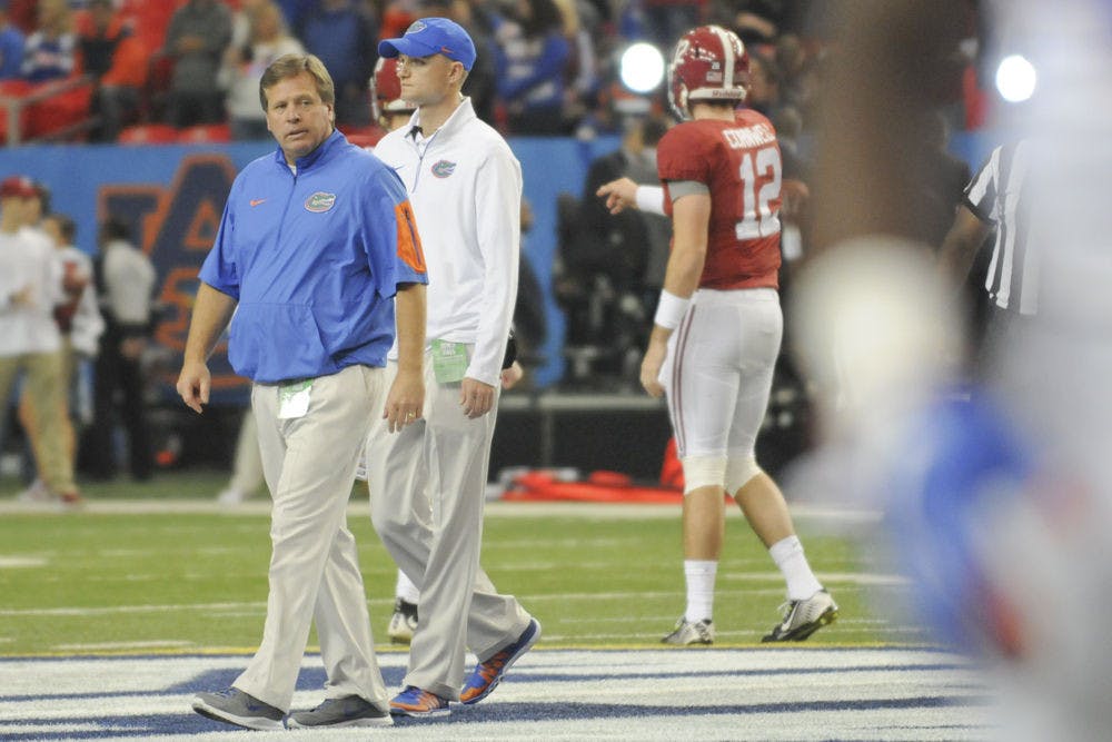 <p>Jim McElwain walks on the field of the Georgia Dome during warmups prior to Florida's 29-15 loss to Alabama in the 2015 SEC Championship Game.</p>