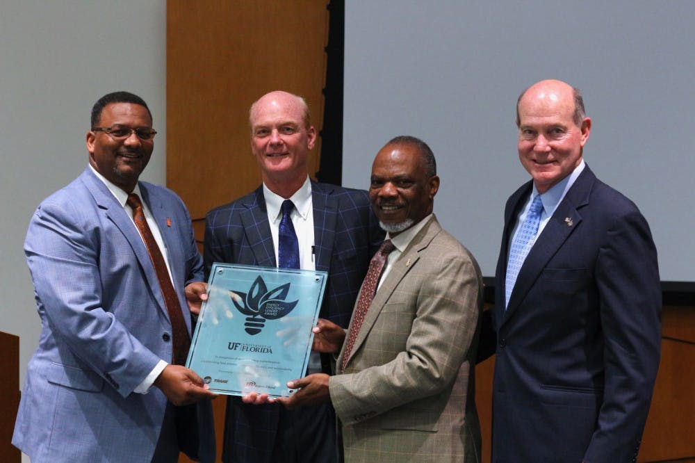 Felix Wilson, the vice president, of Trane’s Southwest and West U.S., presents UF the Trane Energy Efficient Leader Award to Curtis Reynolds, UF’s vice president for business affairs; Eddie Daniels, the assistant vice president for business services; and David Kratzer, a former UF vice president for Student Affairs. The award recognizes the efficient and sustainable approach to the renovation of the Reitz Union.