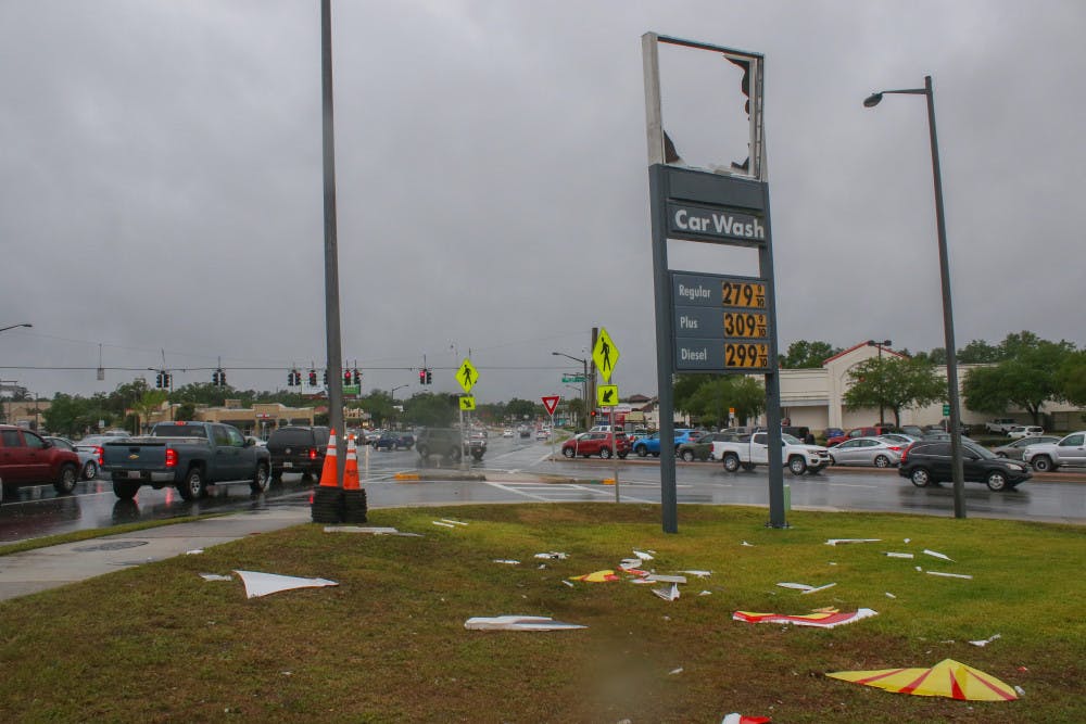 The Shell sign is scattered across the ground Friday after strong winds blew it down during a storm at the Shell gas station, 3330 SW Archer Road. Daphne Roberson, an employee at the station, said she saw the sign go down around 11 a.m. “It just all of a sudden happened,” she said. “I looked up and it was flying across the air.”