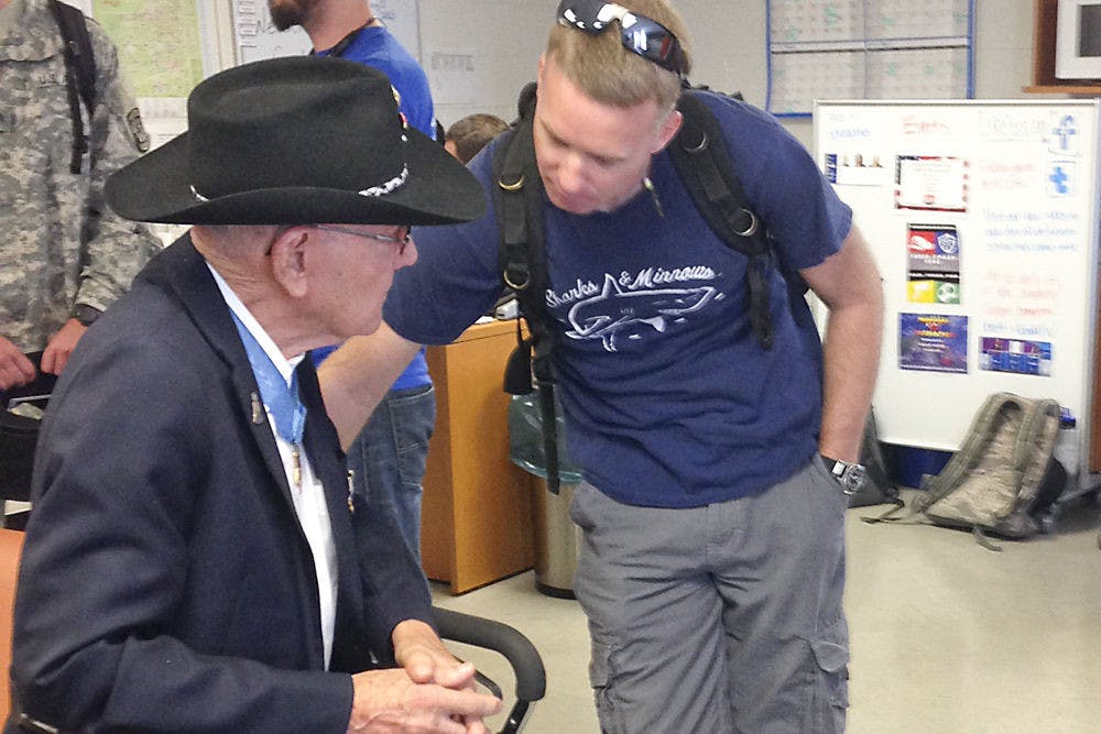 Retired Marine and Medal of Honor recipient Cpl. Duane Dewey speaks with 38-year-old UF materials science sophomore and Marine veteran Nate Adler at the Collegiate Veterans Success Center in Ben Hill Griffin Stadium on Thursday morning. Dewey came to speak to student veterans about his experiences in the Korean War and receiving his Medal of Honor.